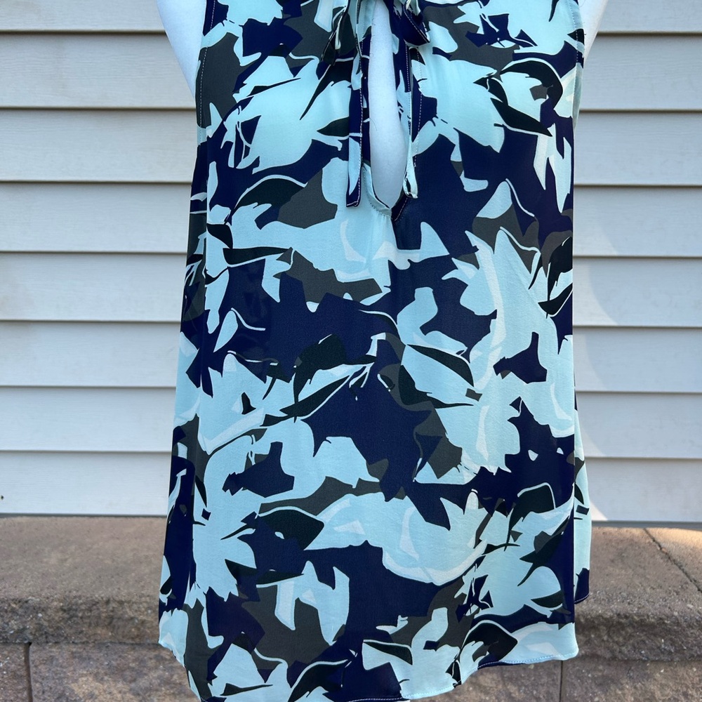 Floral print elegant blouse with ruffle neckline.